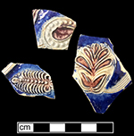 Gray-bodied salt glazed stoneware hollow (mug or jug) with applied  floral motifs painted in cobalt-blue and manganese under the glaze, from 18CV60. Complete vessel with similar motifs shown.